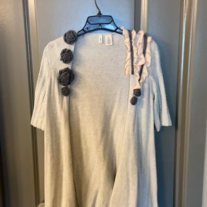 Light sweater with floral detailing.